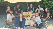 Team members at a picnic table celebrating the graduation of IRTAs and post-doc.